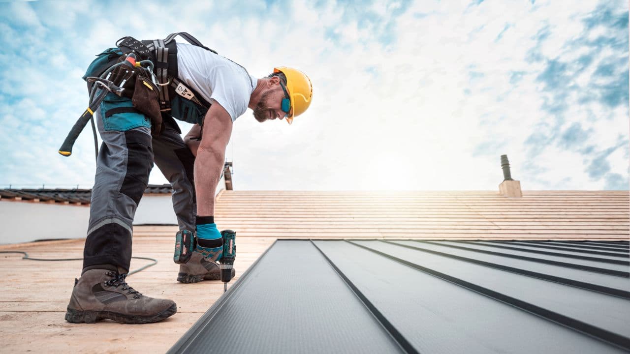 A standing seam metal roof being installed