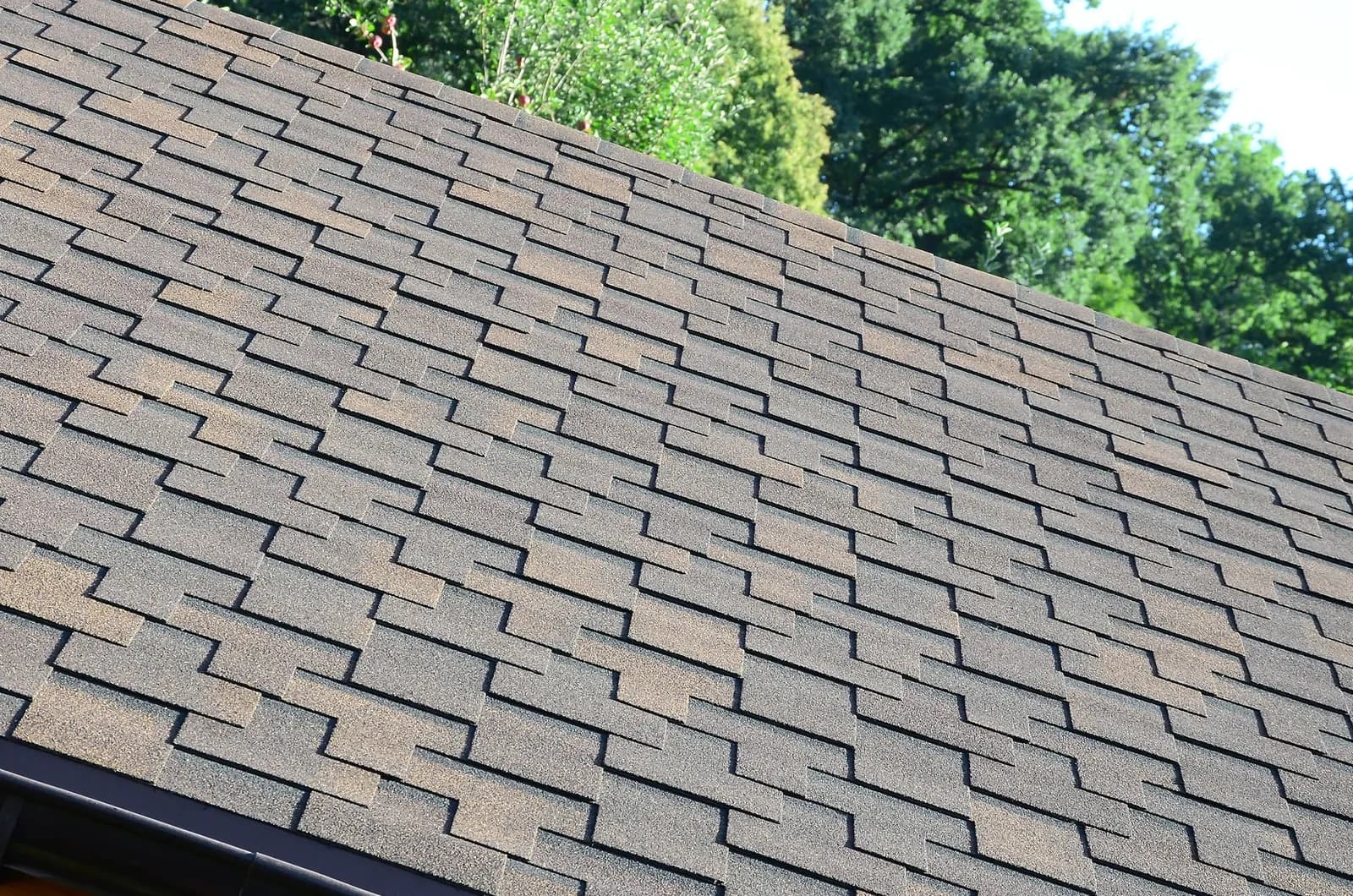 A shingle roof with a brick chimney